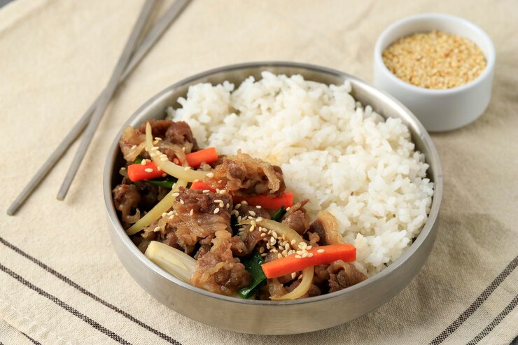 korean-beef-bulgogi-with-stir-fry-vegetable-white-rice-served-stainless-bowl_1048944-10947739